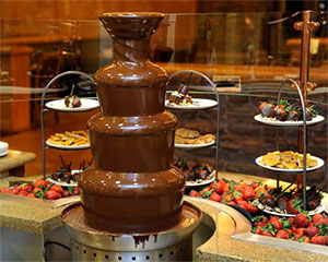 Chocolate fountain and fruit on the buffet line.